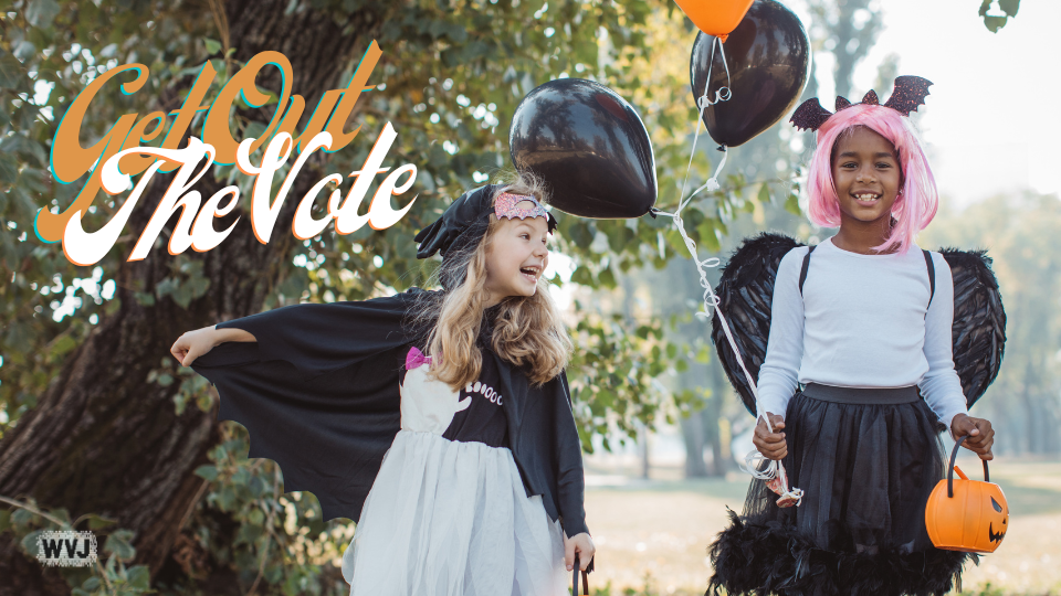 Two children in bat costumes holding balloons and trick-or-treat baskets, with text "Get Out The Vote"